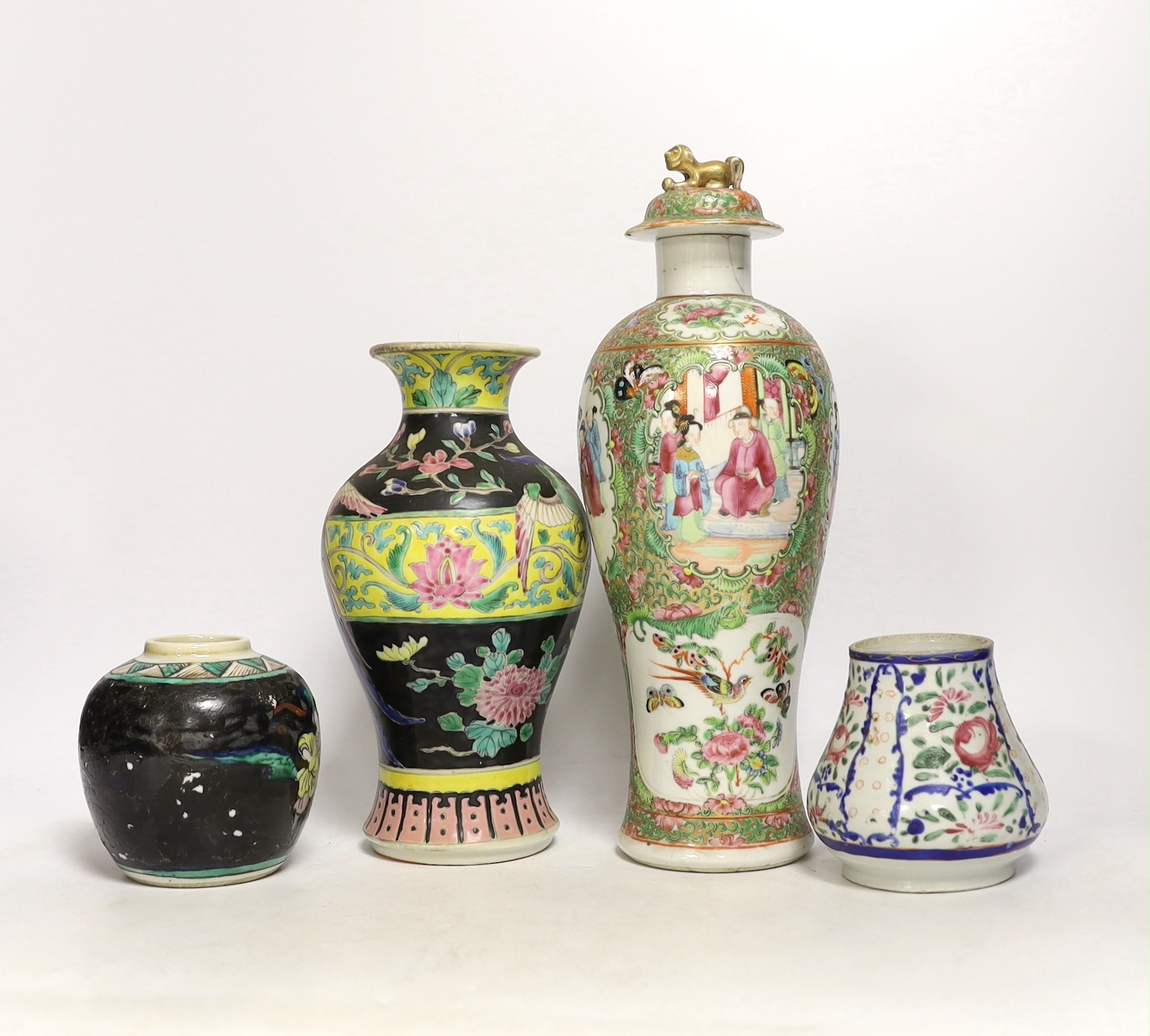 Chinese porcelain- a tall 19th century famille rose vase and cover, a famille rose jar, early 19th century probably made the Indian market, a famille noire jar and a Japanese vase, tallest 28cm high